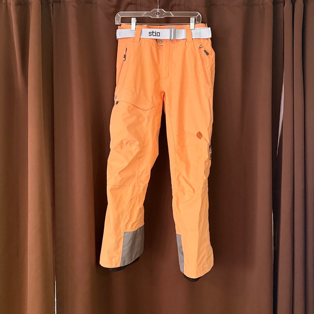 Stio Melon Orange Snowsports Pants with White Belt.